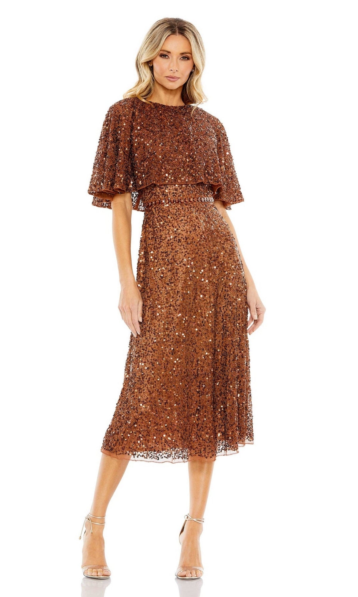 Woman wearing the Mac Duggal 5577 Caped Midi Semi-Formal Dress in bronze sequins with short flutter sleeves and belted waist, paired with nude high-heeled sandals, standing against a white background.